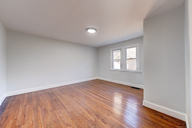 unfurnished room featuring hardwood / wood-style floors