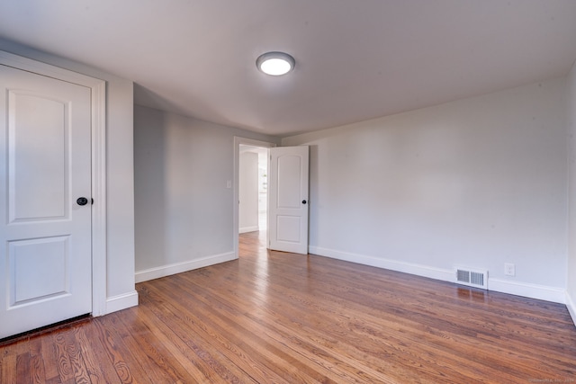 unfurnished room featuring dark hardwood / wood-style flooring