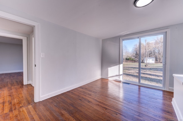 empty room with dark hardwood / wood-style floors