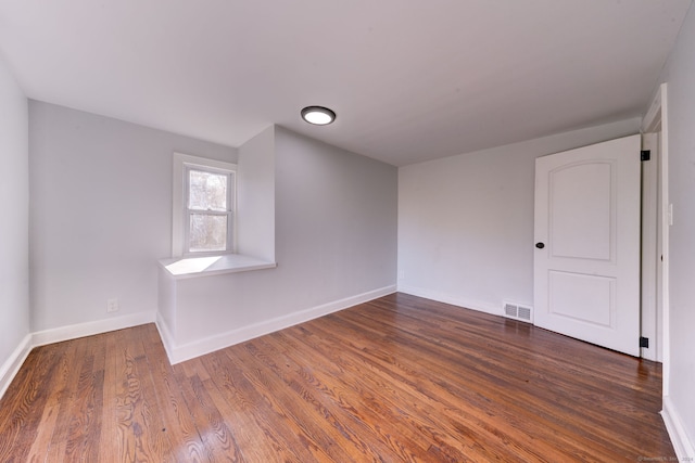 spare room with dark hardwood / wood-style floors