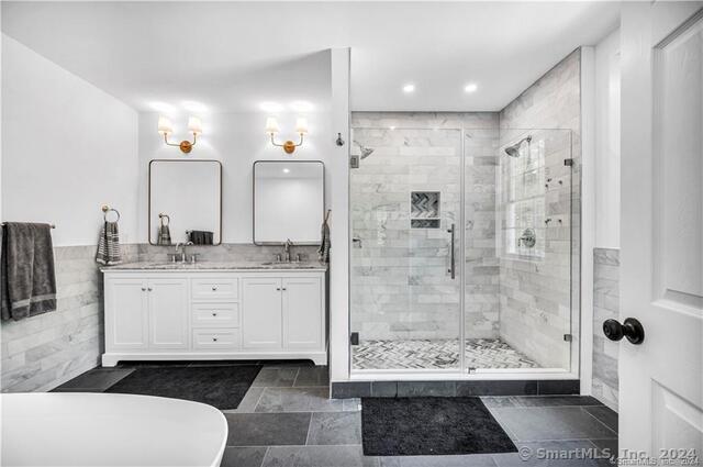 bathroom with an enclosed shower and vanity