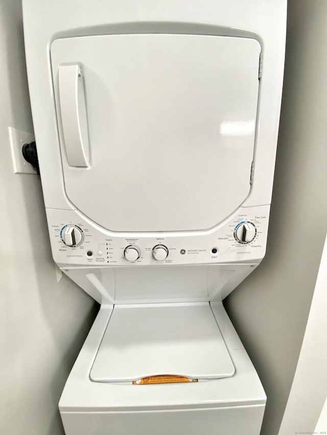 washroom with stacked washer / drying machine