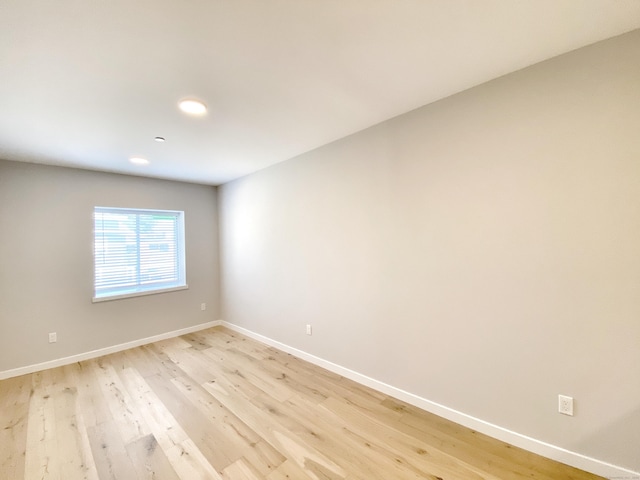 unfurnished room with light hardwood / wood-style floors