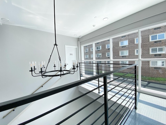 hallway with a notable chandelier