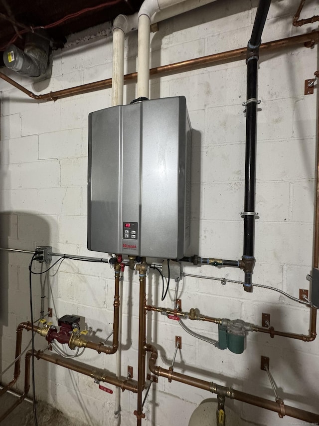 utility room featuring tankless water heater