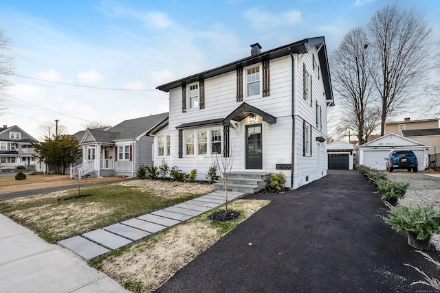 view of front of property with an outdoor structure and a garage