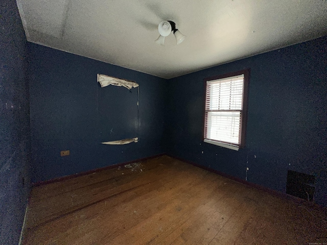 spare room featuring hardwood / wood-style floors