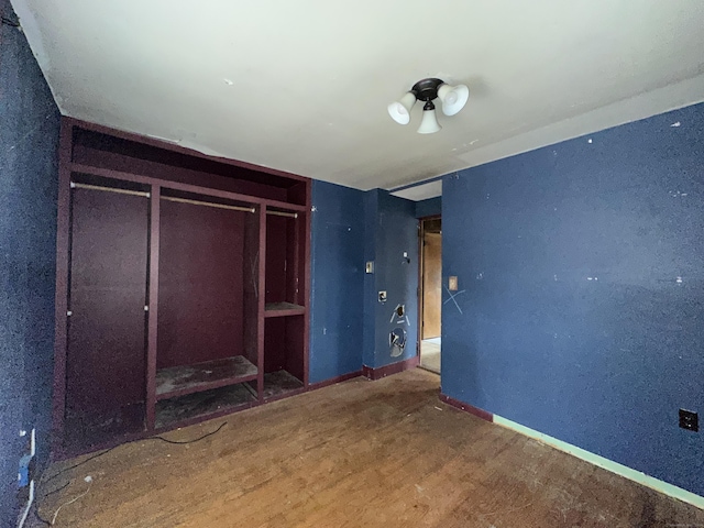 unfurnished bedroom featuring wood-type flooring and a closet