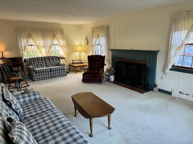 carpeted living room featuring a baseboard heating unit