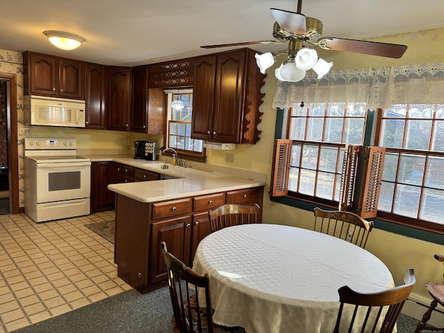 kitchen featuring white appliances, ceiling fan, a healthy amount of sunlight, and sink