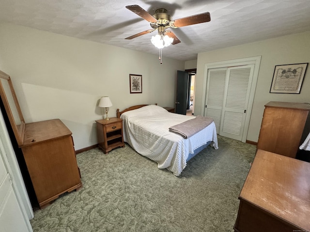 carpeted bedroom featuring ceiling fan, a closet, and a textured ceiling