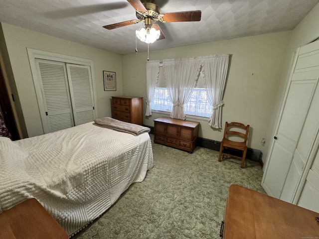 carpeted bedroom featuring ceiling fan and a closet