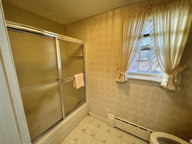 bathroom with toilet, a baseboard heating unit, and enclosed tub / shower combo