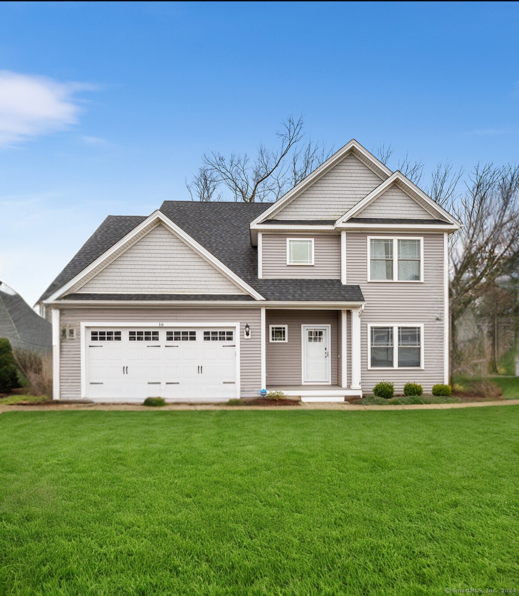 craftsman inspired home featuring a front yard and a garage