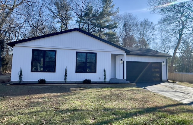 view of front of home with a garage and a front yard