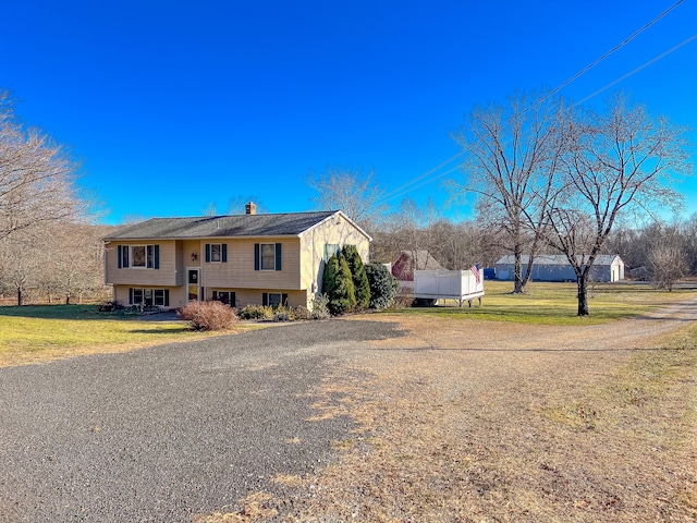 raised ranch with a front lawn