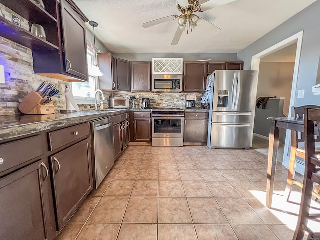 kitchen with pendant lighting, ceiling fan, tasteful backsplash, light tile patterned flooring, and stainless steel appliances