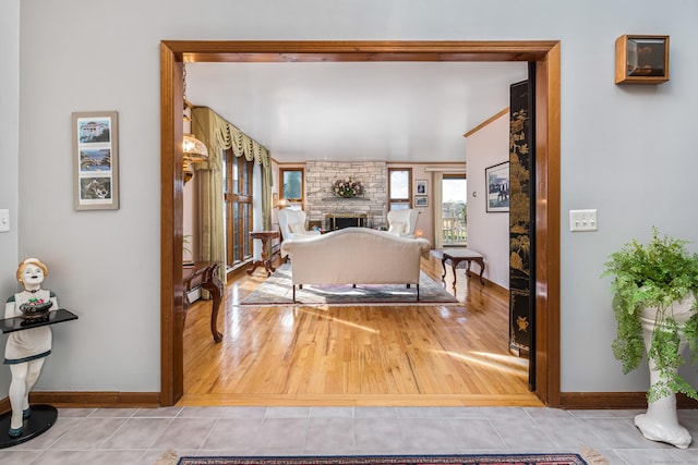 bedroom with a stone fireplace and tile patterned flooring