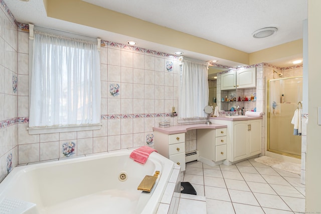 bathroom featuring a baseboard heating unit, tile patterned floors, separate shower and tub, vanity, and tile walls