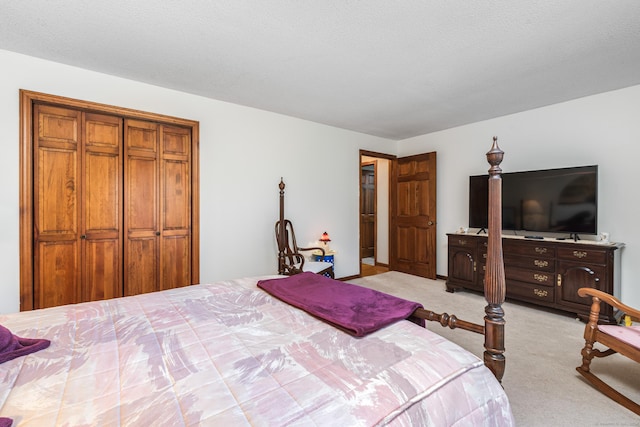 carpeted bedroom featuring a textured ceiling and a closet