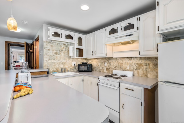 kitchen with decorative backsplash, white cabinetry, white appliances, and hanging light fixtures