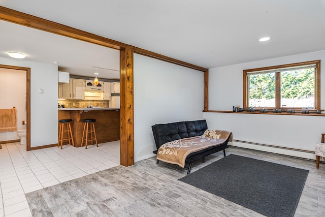 sitting room featuring light tile patterned floors and baseboard heating