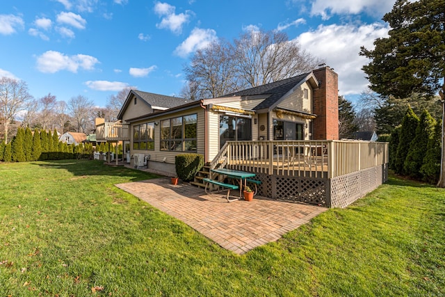 back of property with a patio area, a yard, and a deck