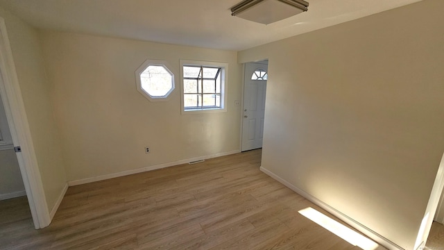 spare room with light hardwood / wood-style flooring