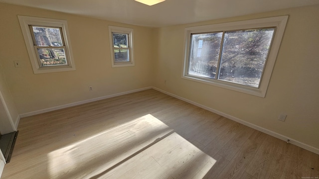 empty room with a healthy amount of sunlight and light wood-type flooring