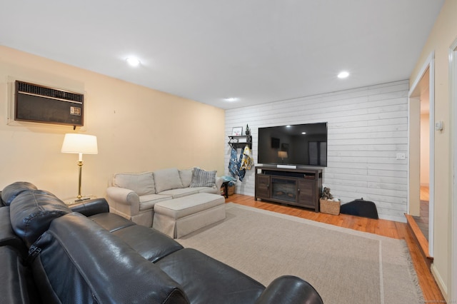 living room with wood-type flooring and a wall mounted AC