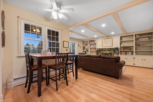 dining space featuring beam ceiling, light wood-type flooring, ceiling fan, and a baseboard heating unit