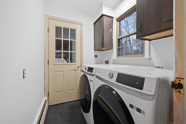 washroom with washing machine and dryer, dark tile patterned floors, cabinets, and a baseboard radiator