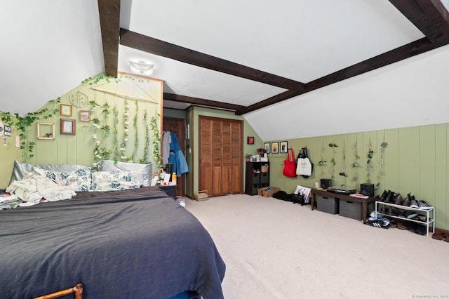 bedroom featuring carpet and vaulted ceiling with beams