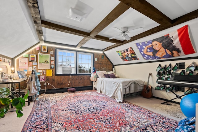 bedroom with beamed ceiling, ceiling fan, carpet floors, and wooden walls