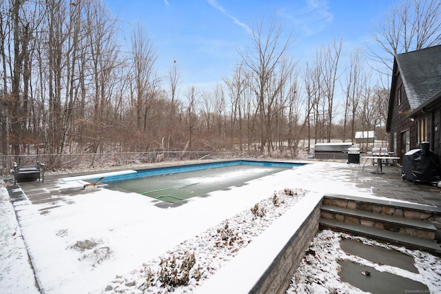 snow covered pool with a diving board