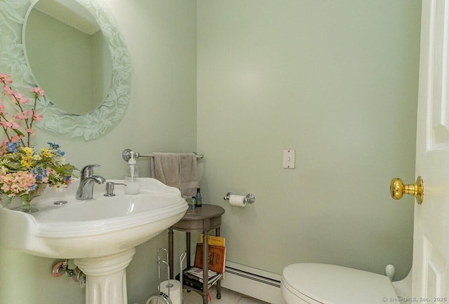 bathroom featuring a baseboard radiator and toilet