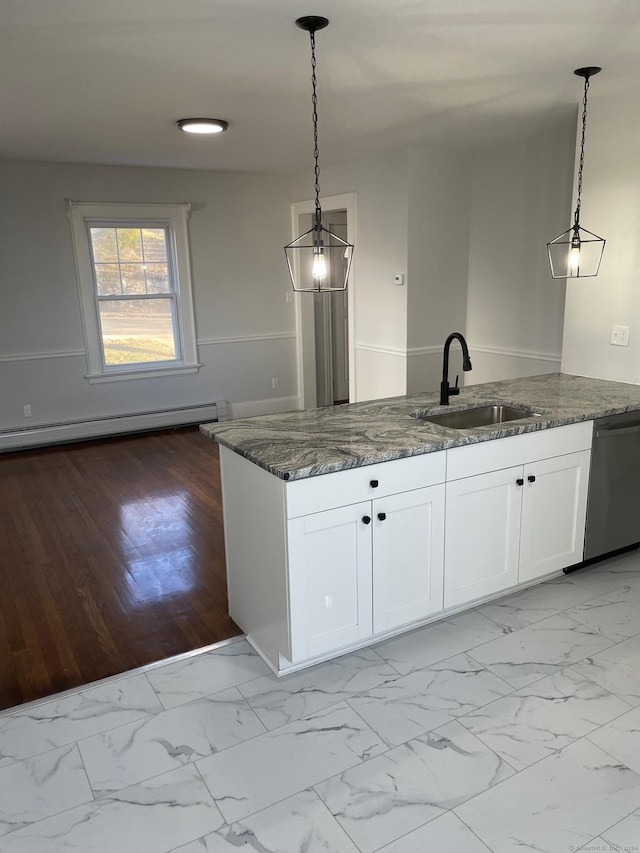 kitchen with pendant lighting, light wood-type flooring, white cabinetry, and sink