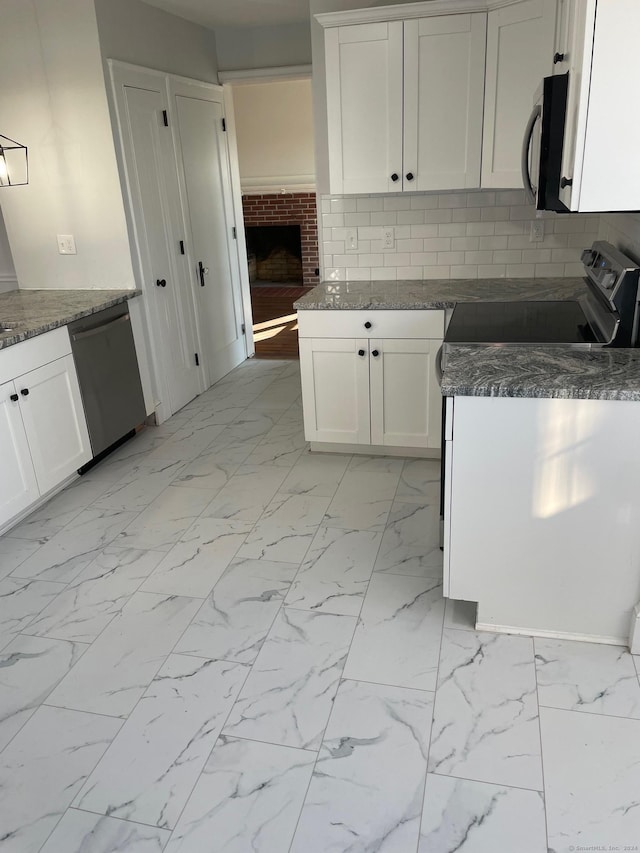 kitchen featuring tasteful backsplash, white cabinets, and stainless steel appliances