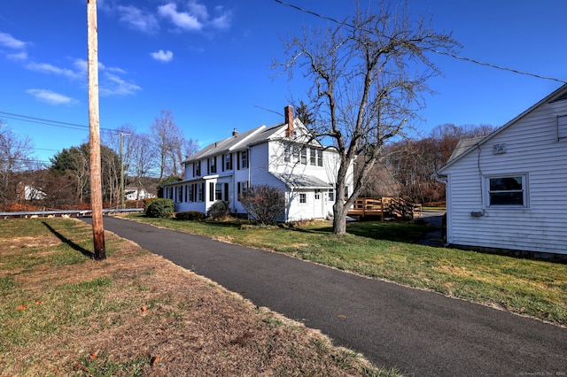 view of front of home featuring a front lawn and a sunroom