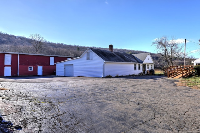 view of home's exterior with an outbuilding and a garage