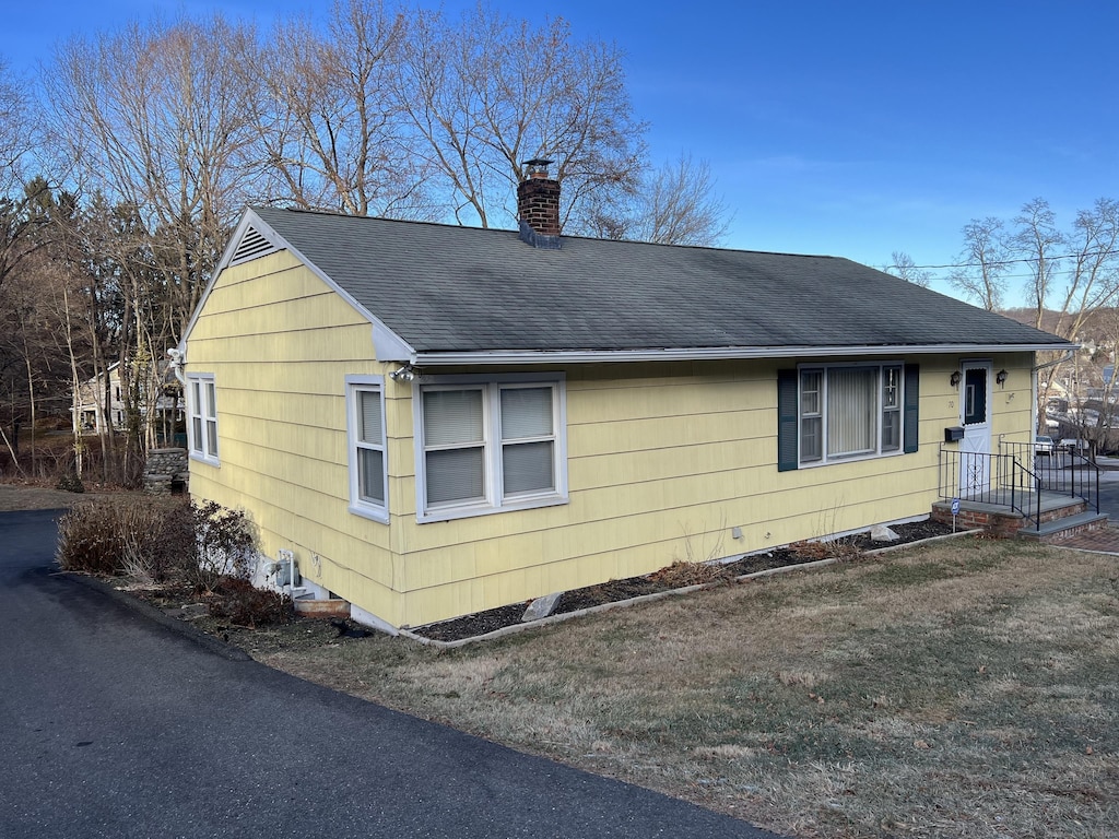 view of side of home featuring a yard