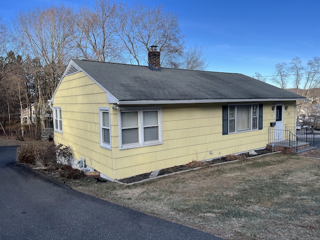 view of side of home featuring a yard