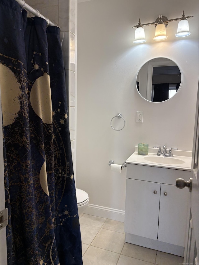 bathroom with tile patterned flooring, vanity, and toilet