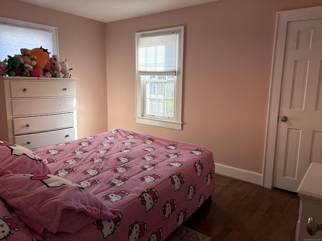 bedroom with dark hardwood / wood-style floors