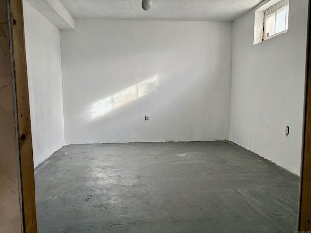 unfurnished room with concrete flooring