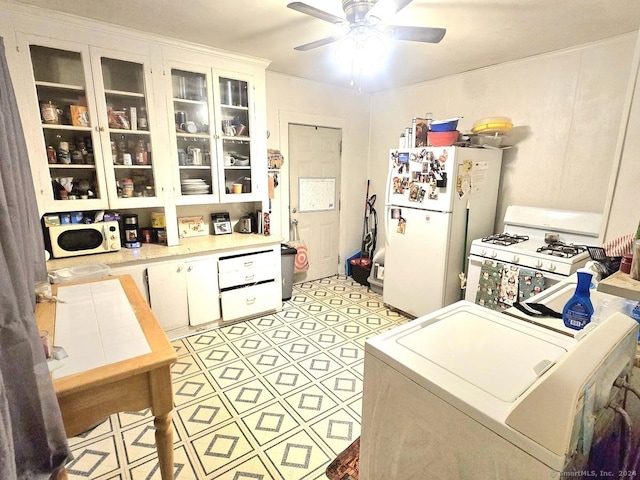 kitchen featuring washer / clothes dryer, ceiling fan, white cabinets, and white appliances