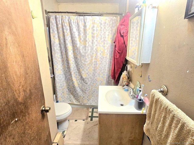 bathroom featuring vanity, toilet, and walk in shower