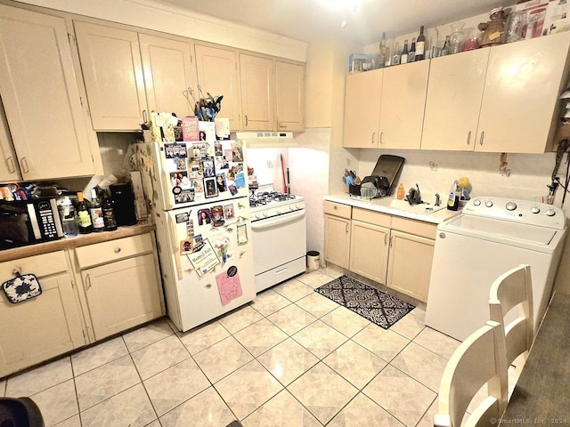 kitchen featuring decorative backsplash, white appliances, sink, washer / dryer, and light tile patterned flooring