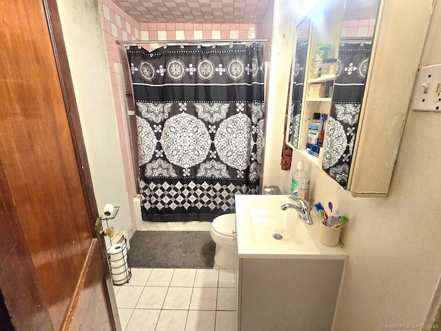 bathroom with tile patterned flooring, vanity, toilet, and a shower with shower curtain