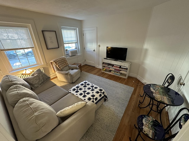 living room with cooling unit and hardwood / wood-style flooring